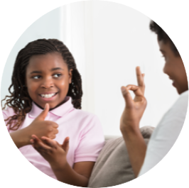 Photo of a woman and child speaking in sign language