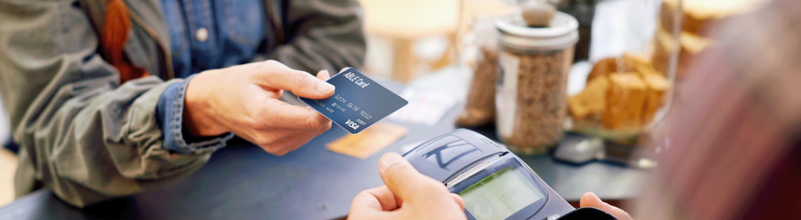 Photo of a woman paying with a card