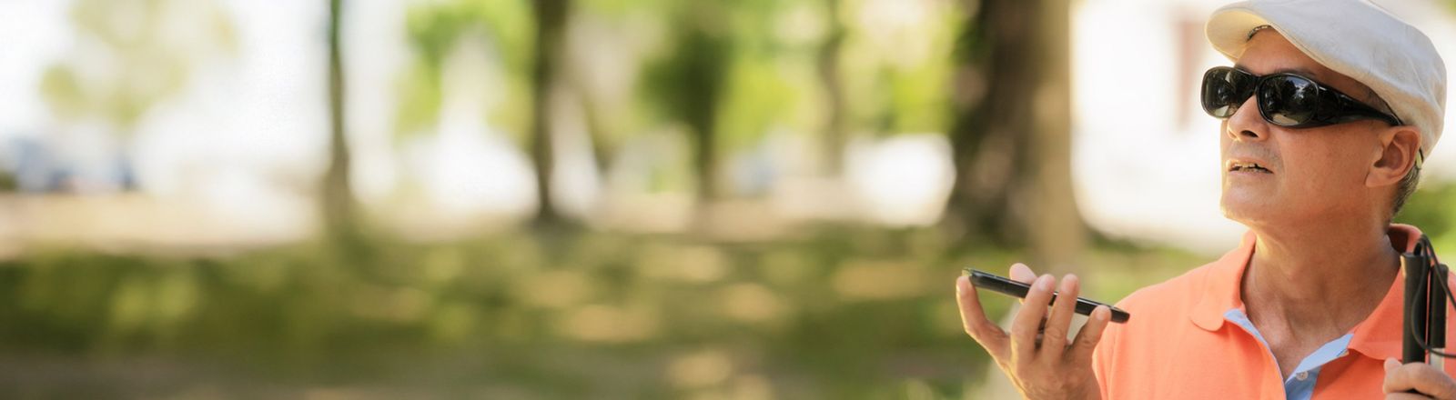 Photo of a young boy in a wheelchair hitting a ball with a bat